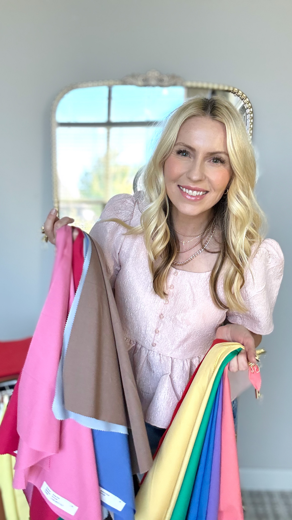 Janne Coussens, Certified Color Analyst, holding seasonal color drapes.